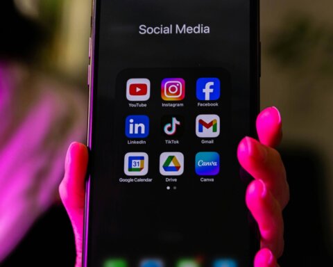 Smartphone screen displaying social media apps including YouTube, Instagram, Facebook, LinkedIn, TikTok, Gmail, Google Calendar, Drive, and Canva.