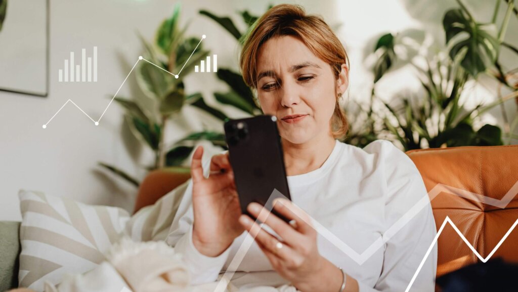 Woman in white shirt using iPhone on couch with digital graphs overlay and plants in background