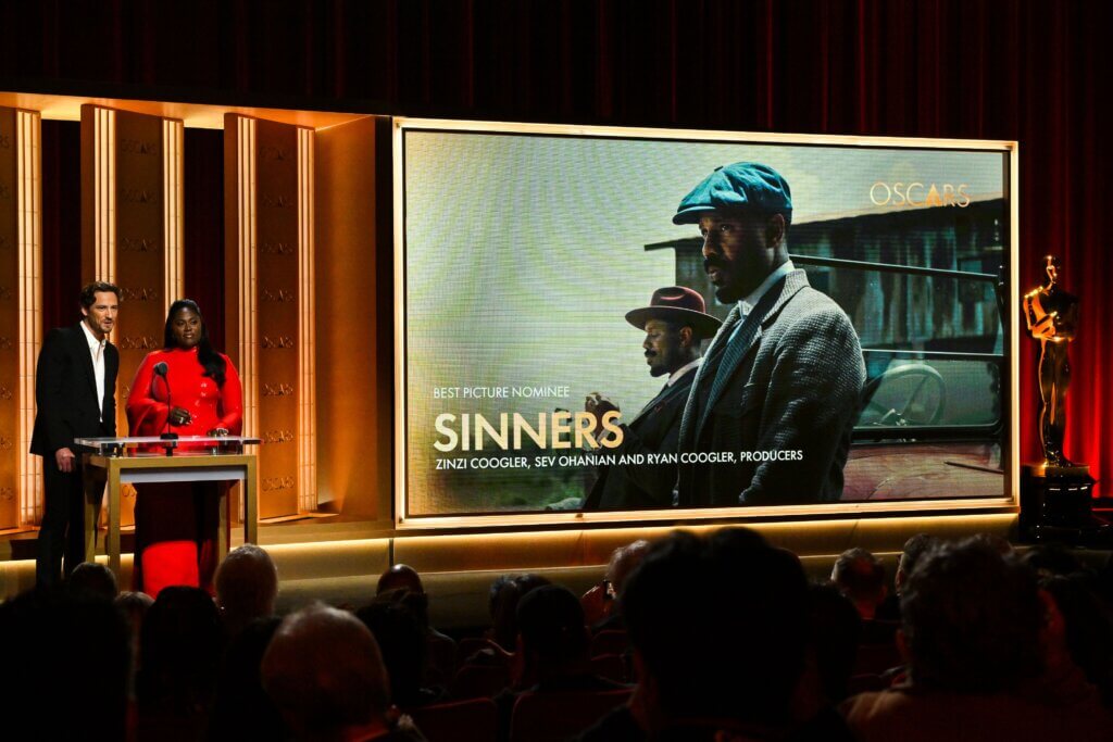 Presenters announcing the Best Picture nominee "Sinners" at the Oscars ceremony.