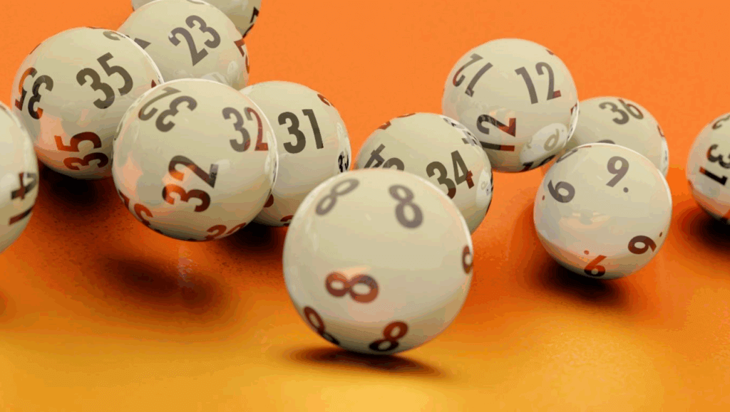 White lottery balls with black numbers scattered on an orange surface