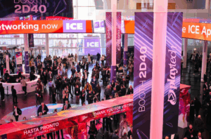Crowd at ICE gaming event near Playtech booth 2D40 with networking banners and signage.