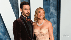 Dave Franco in a velvet suit and Hilary Duff in a strapless lace dress with pearl necklace at a formal event