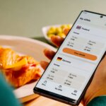 Person holding a smartphone displaying eSIM packages for Thailand and Germany with data, calls, and texts details.