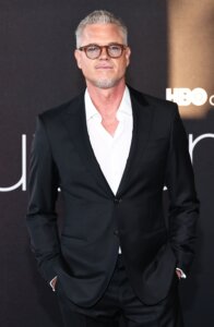 Eric Dane wearing a black suit and glasses at an HBO event.