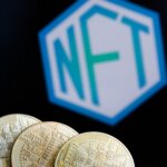 Three gold cryptocurrency coins in front of a blurred hexagonal NFT logo on a black background