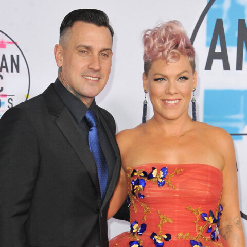 Pink and Carey Hart posing on the red carpet at the American Music Awards