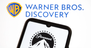 Paramount logo displayed on a smartphone screen with Warner Bros. Discovery logo in the background