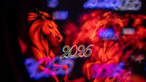 Red horse illustration with the year 2026 repeated in colorful light reflections on a black background.