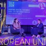 Two women speaking on stage at EU@SXSW event titled "Shaping Digital Futures" in Austin, Texas.