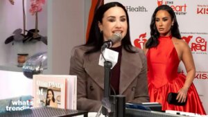 Demi Lovato blames "the suits" for her viral heart attack blunder while teasing Camp Rock 3 and a new cookbook.