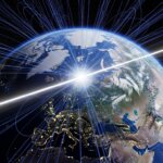 Earth viewed from space showing magnetic field lines and the geomagnetic axis with arrows.