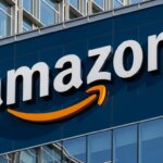 Amazon logo on the exterior of a modern glass office building