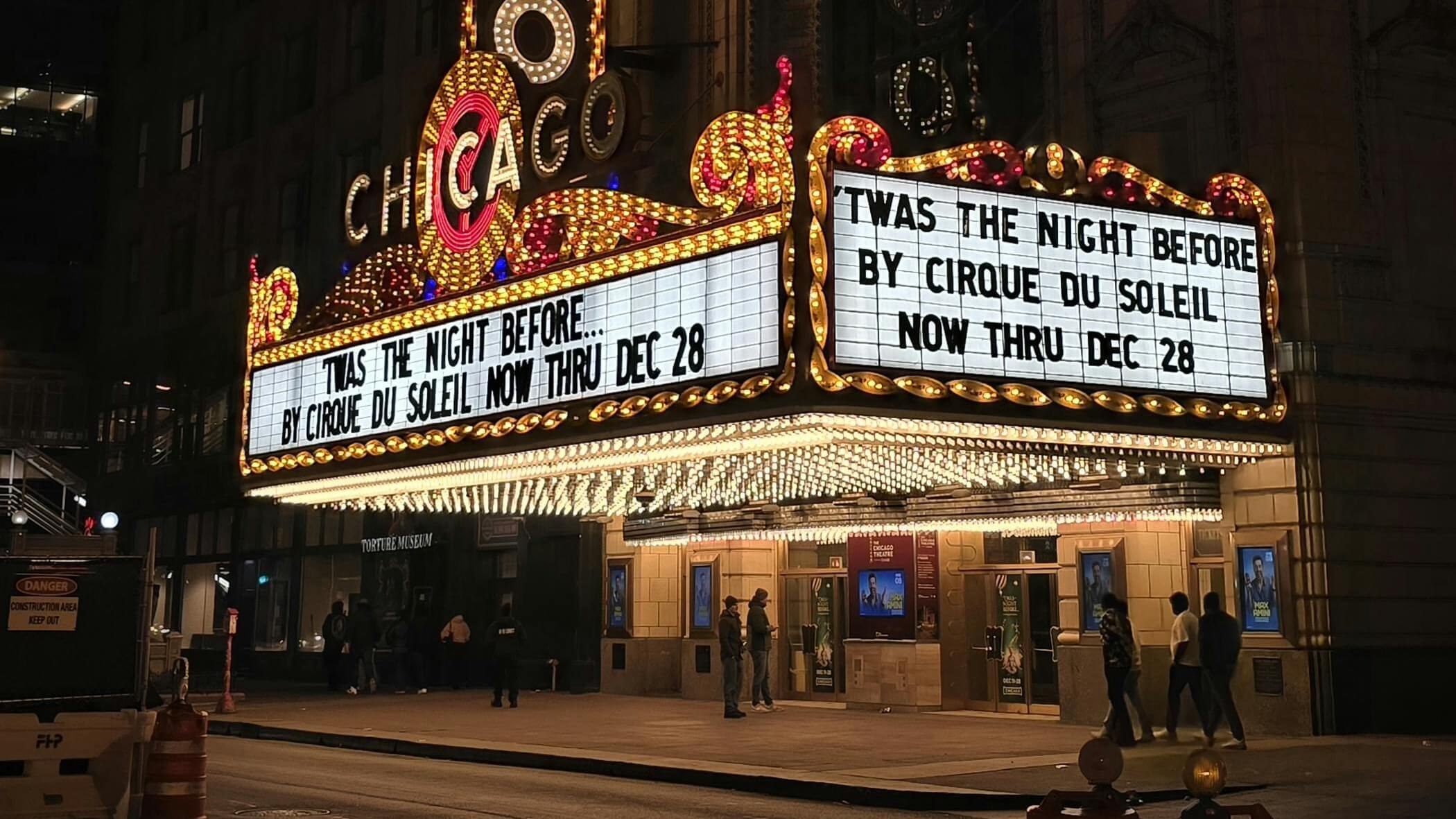 Chicago Theatre marquee lit up at night promoting Cirque du Soleil's "'Twas the Night Before" show through December 28