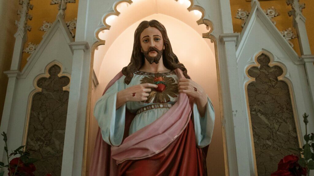 Statue of Jesus Christ pointing to the Sacred Heart inside a church altar niche