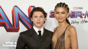 Tom Holland and Zendaya posing at the Spider-Man: No Way Home premiere with Marvel Studios logo in background
