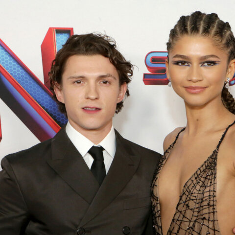 Tom Holland and Zendaya posing at the Spider-Man: No Way Home premiere with Marvel Studios logo in background