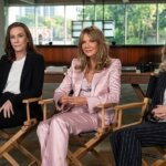 Kathryn Kates, Michelle Pfeiffer, and Kim Cattrall seated in director chairs in a modern office setting.