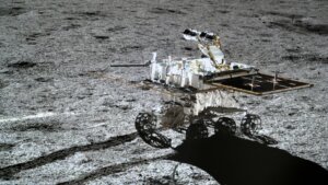Chinese lunar rover Yutu on the moon's surface with visible tracks in the lunar soil