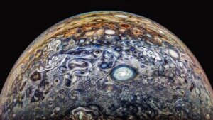 Close-up of Jupiter's swirling cloud patterns and storms against black space background.