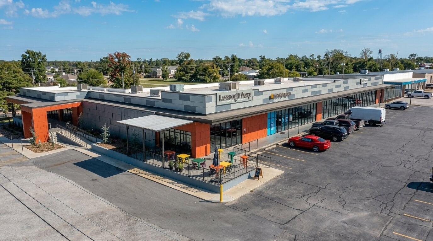 Lansdowne Veterinary Hospital and Ink & Paper storefronts in a modern shopping plaza with outdoor seating and parked cars.