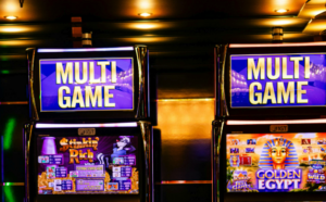 Two slot machines displaying "MULTI GAME" with games "Stinkin' Rich" and "Golden Egypt" in a casino setting.