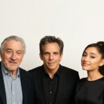 Robert De Niro, Ben Stiller, and Ariana Grande posing together against a plain background