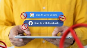 Person holding tablet with disabled sign-in options for Google and Facebook accounts.