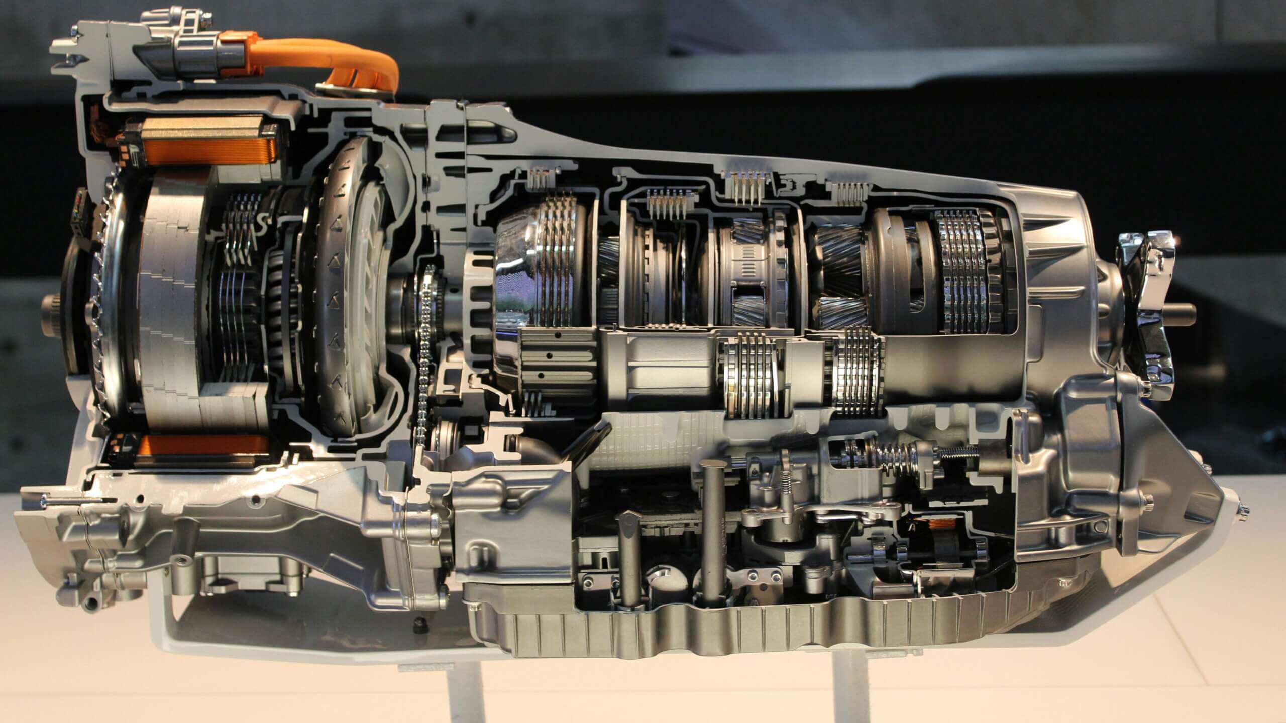 Cutaway view of a car automatic transmission showing internal gears and components.