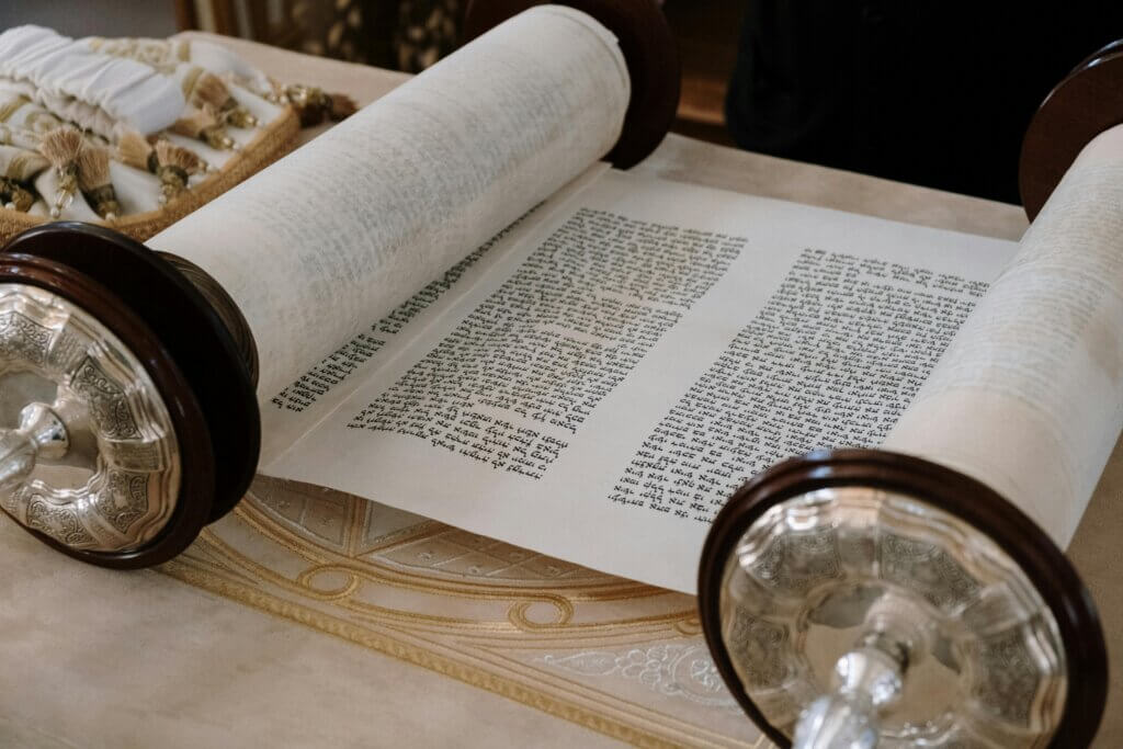 Open Torah scroll with Hebrew text on a decorative table cover