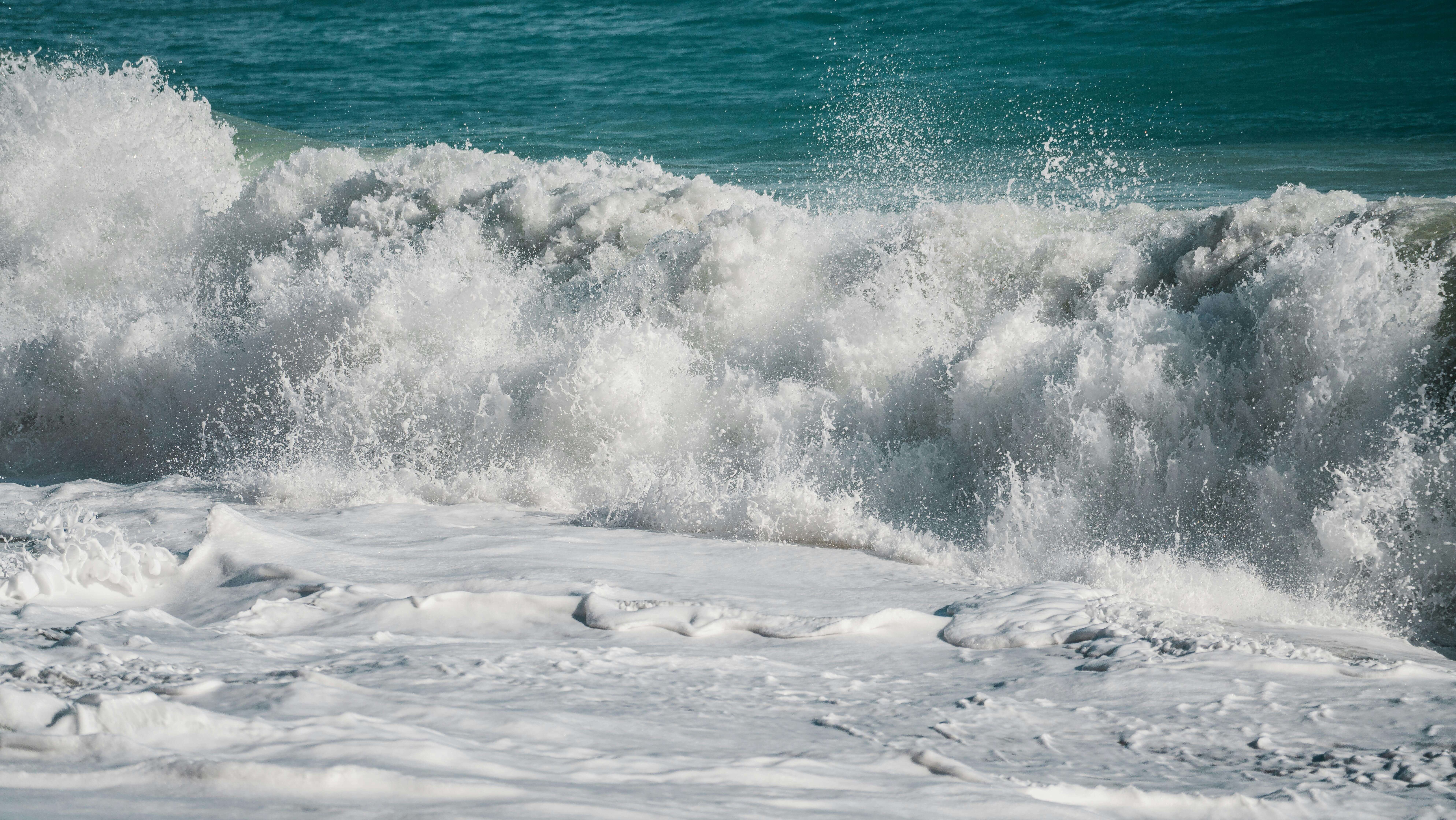 White ocean waves crashing with turquoise water in the background