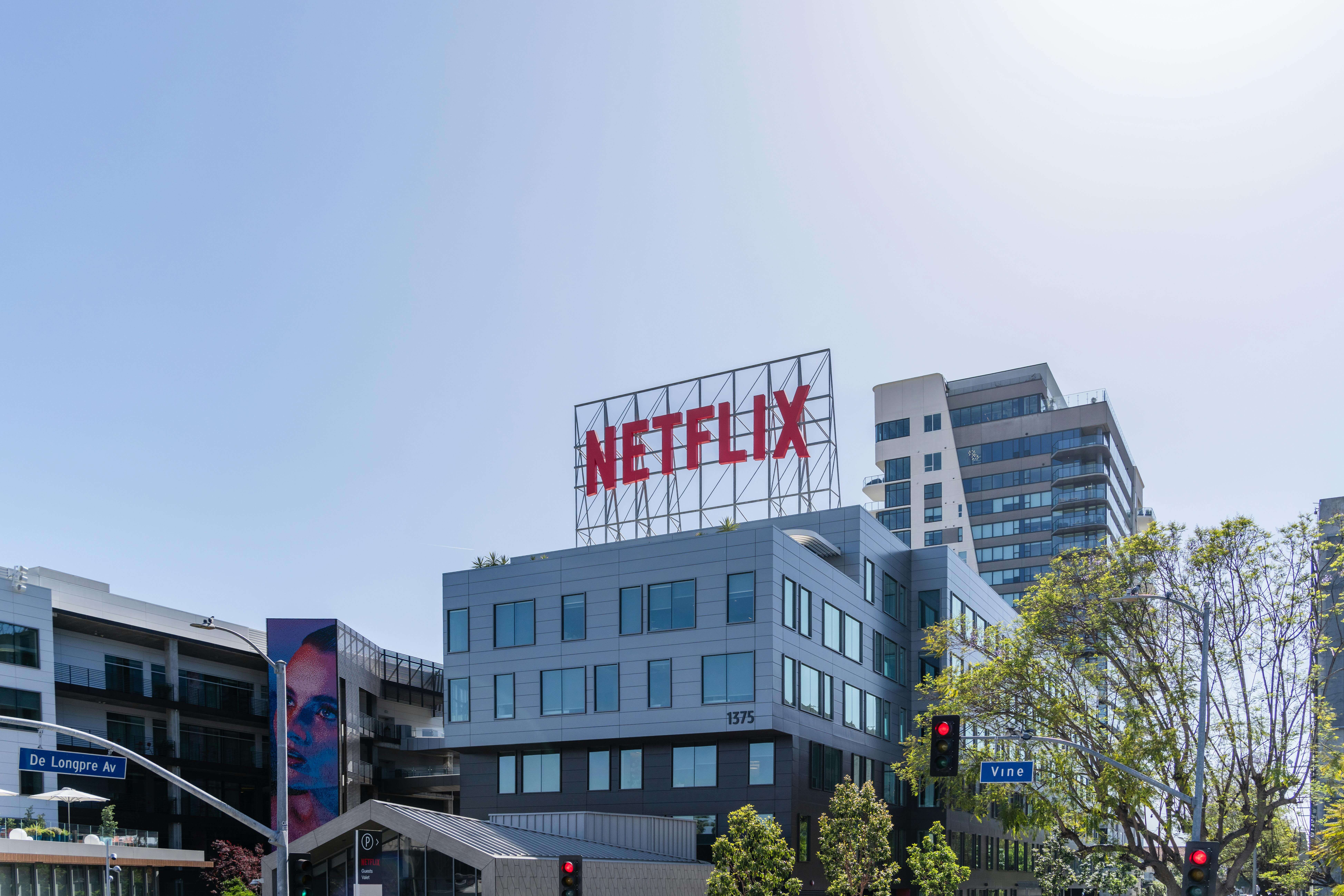 Netflix headquarters building with large red Netflix sign on the roof at De Longpre Avenue and Vine Street intersection