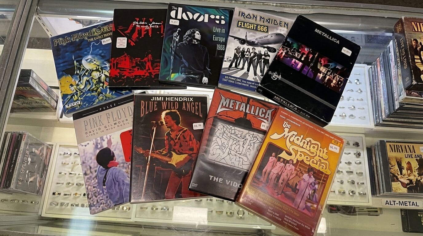 Collection of classic rock and metal VHS tapes including Pink Floyd, Jimi Hendrix, Metallica, Iron Maiden, The Doors, and The Midnight Special.