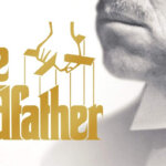 Marlon Brando as Vito Corleone in The Godfather movie poster with a bullet-riddled car and a man lying on the ground.