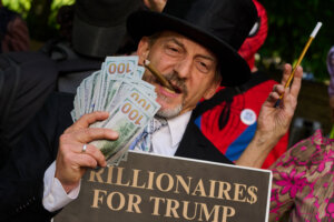 Man in top hat holding cigar, fan of $100 bills, and sign reading "Billionaires for Trump"