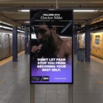 Subway platform with digital ad featuring Doctor Mike boxing and text "Don't let fear stop you from becoming your best self."