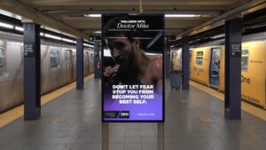 Subway platform with digital ad featuring Doctor Mike boxing and text "Don't let fear stop you from becoming your best self."