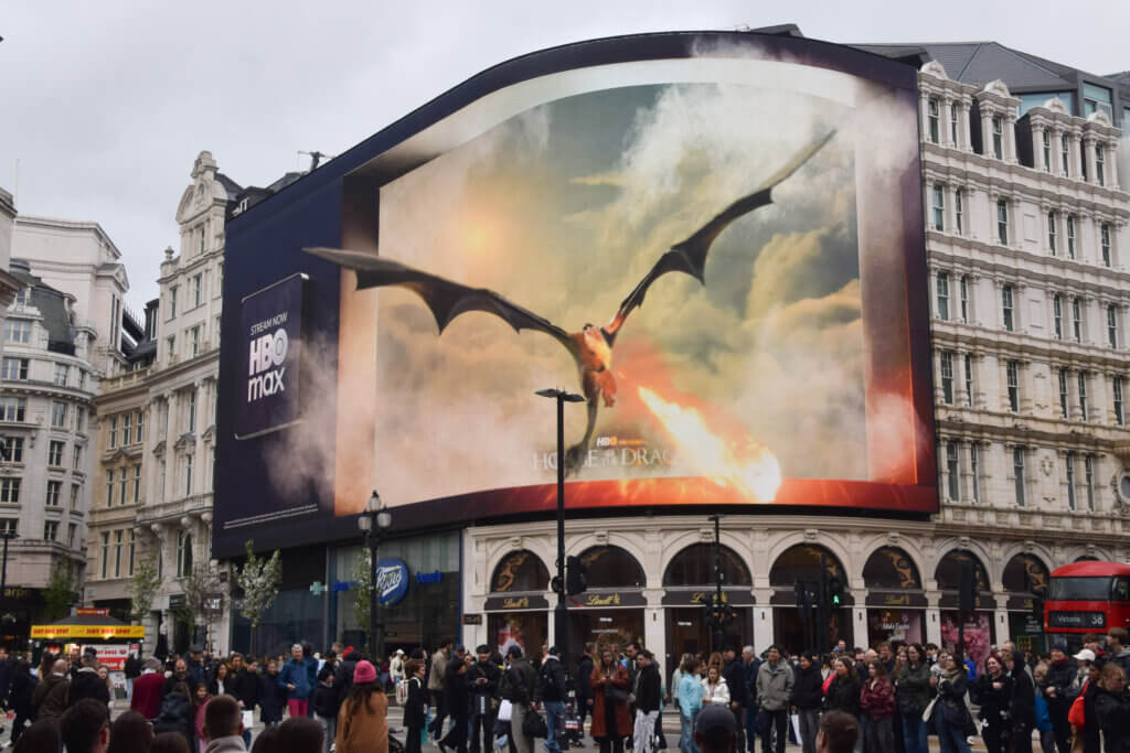 Large HBO Max billboard in a city showing a dragon breathing fire from the series House of the Dragon