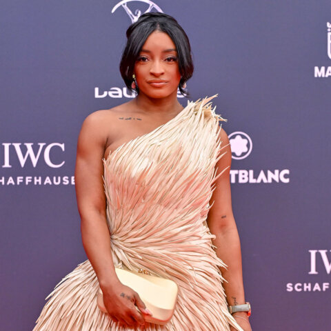 Woman in a textured beige one-shoulder dress holding a cream clutch at the Laureus Awards in Madrid