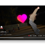 Skateboarder stellas_gr00v3 performing a kickflip at night in a skatepark with spectators in the background.