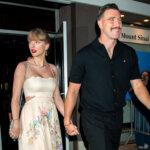 Taylor Swift and Travis Kelce holding hands outside Mount Sinai Doctors with fans taking photos nearby