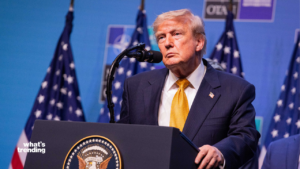 Donald Trump speaking at a podium with the presidential seal and American flags in the background
