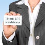 Person in pinstripe suit holding a card that says "Terms and conditions"
