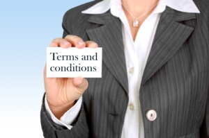 Person in pinstripe suit holding a card that says "Terms and conditions"