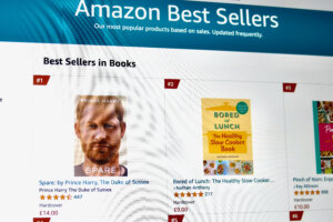 Amazon Best Sellers page showing top books including "Spare" by Prince Harry and "Bored of Lunch" by Nathan Anthony.