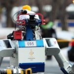 KAIST humanoid robot holding the lit Olympic torch during the PyeongChang 2018 Winter Olympics.