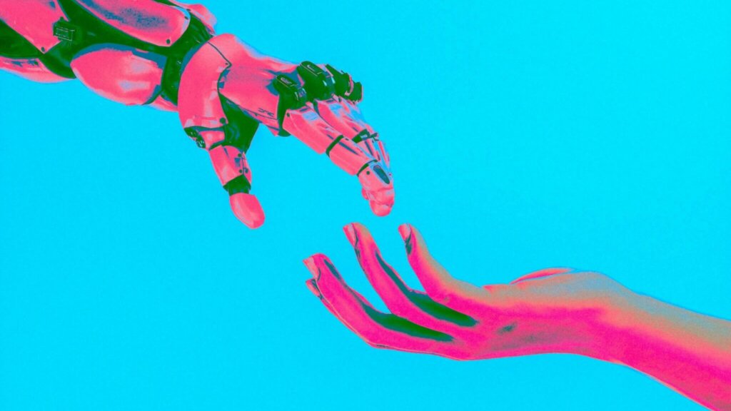 Human hand reaching toward a robotic hand against a bright blue background with pink and green lighting effects