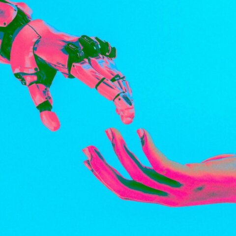 Human hand reaching toward a robotic hand against a bright blue background with pink and green lighting effects
