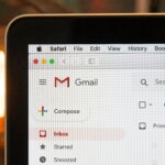 MacBook screen showing Gmail inbox open in Safari browser with Compose button visible