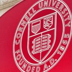 Red awning with Cornell University seal and number 6 above an entrance.