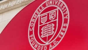 Red awning with Cornell University seal and number 6 above an entrance.
